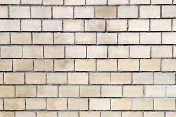 Texture of an old abd dirty wall made of beige rectangular tiles as a background