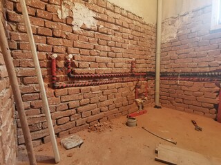 Water pipes made of polypropylene in the wall, plumbing in the house. Installation of sewer pipes in a bathroom of an apartment - obrazy, fototapety, plakaty