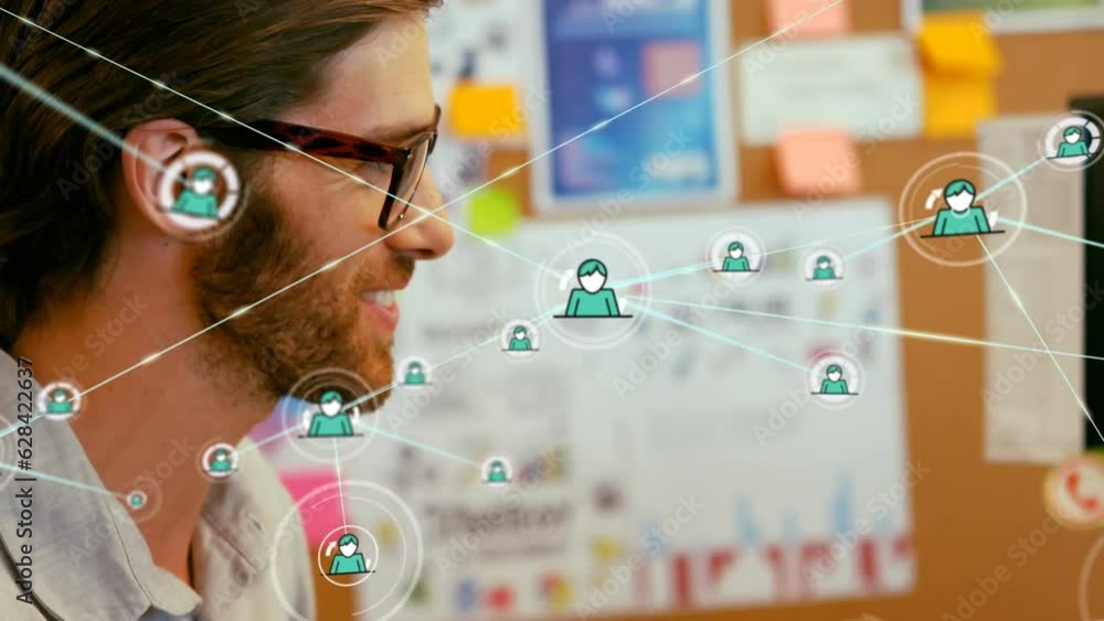 Poster animation of network of profiles over caucasian man smiling while using graphic tablet at office