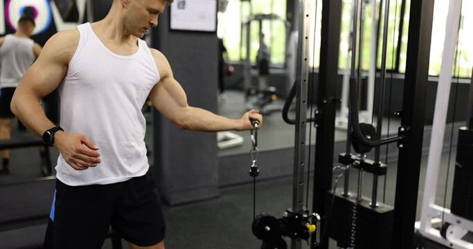 Chest workout and curling arms for biceps in gym. Indoor bodybuilding and weight lifting
