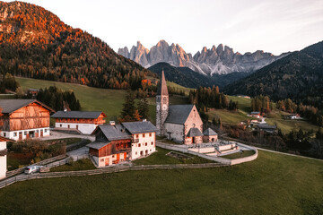 Fototapeta na wymiar Drone photo of church and village in Santa Maddalena Magdalena Dolomites Italy