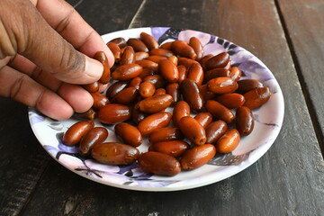 Date palm fruits. Its other names 
Phoenix dactylifera. It is a flowering plant species in the palm family, Arecaceae, cultivated for its edible sweet fruit called dates.
