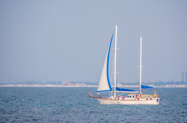 Obraz premium Sailing yacht in the blue calm sea.