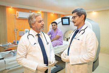 Two doctor discussing before proceeding of MRI at hospital.