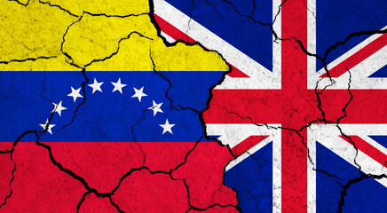Flags of Venezuela and United Kingdom on cracked surface - politics, relationship concept
