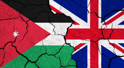 Flags of Jordan and United Kingdom on cracked surface - politics, relationship concept