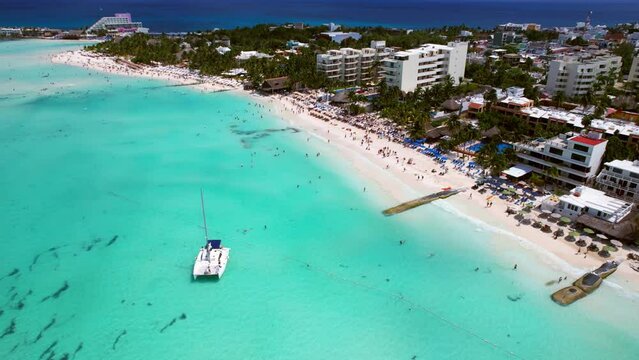 Luxury Boat Anchored In Blue Water Off Resort Island Playa Norte, Isla Mujeres Mexico, 4K Drone Flyover