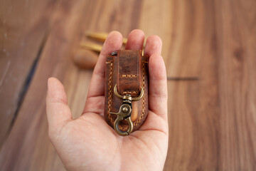 Vintage style mini size leather knife sheath with rustic buckle in hand. Small folding knife sheath made by rustic leather.	