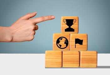 KPI concept. Businessman holds wooden cube