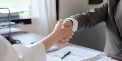 Closeup Handshake of businesspeople and a partner after planning strategy marketing in the office