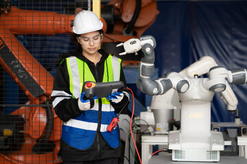 Fototapeta premium Mechanical engineering people training, programming automated AI robot arms connection at production factory. Smart female industrial engineer working at heavy futuristic robotic machinery industry.