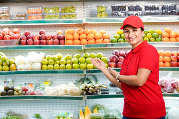Indian woman seller giving expression at supermarket.