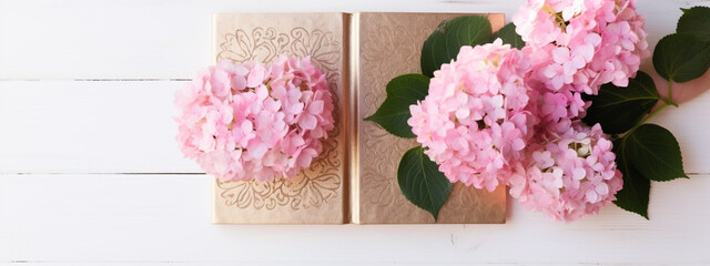 Golden book, box, surrounded by flowers and leaves of pink hydrangea on a white wooden background. Mockup, background for publications, presentations, advertising