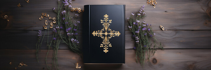 a bible in a black cover with a golden cross on a wooden table surrounded by lavender flowers. Religious Christian background, banner, mockup
