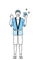 預金通帳を見て喜ぶ夏祭りの法被を着たシニア男性