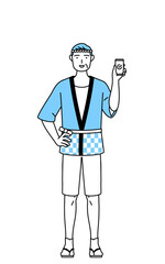 仕事でスマホを使う夏祭りの法被を着たシニア男性