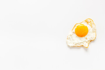 Fried egg close up on white background, top view. Breakfast concept
