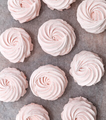 homemade marshmallow zephyr with strawberry taste on wooden boards. strawberries slice , sugar powder top view.food photography