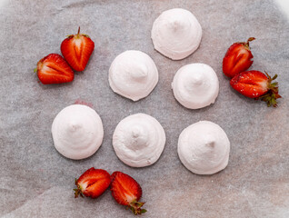 homemade marshmallow zephyr with strawberry taste on wooden boards. strawberries slice , sugar powder top view.food photography