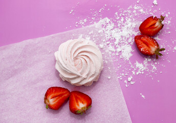 homemade marshmallow zephyr with strawberry taste on wooden boards. strawberries slice , sugar powder top view.food photography