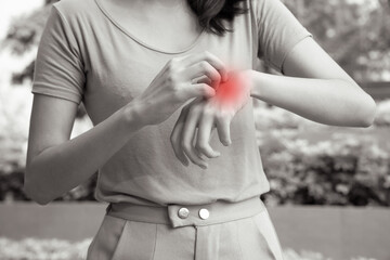 Asian woman scratching her hand skin; concept of dry skin, allergic skin inflammation, body care,...