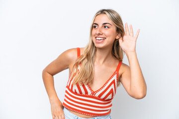 Young caucasian woman isolated on white background listening to something by putting hand on the ear