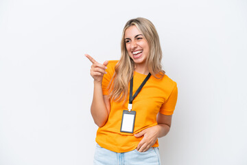 Young caucasian woman with ID card isolated on white background pointing finger to the side and presenting a product