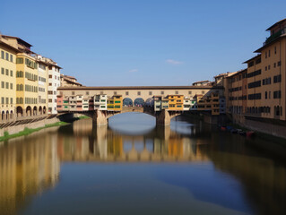 Obraz premium The Ponte Vecchio (Old Bridge) in Florence, Italy, seen on a clear sunny day. Frontal view. Travel photography