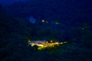 A Train run through the mountains and forests. Small railway station at night. Along the Pingxi line, there are river valleys, potholes and waterfalls. Taiwan