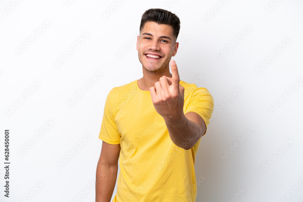 Wall mural Young caucasian man isolated on white background doing coming gesture