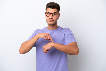 Young caucasian man isolated on white background making the gesture of being late