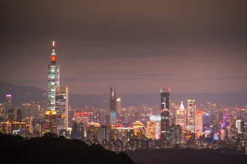 At dusk, the night view of Taipei gradually brightens. Dynamic clouds. View of the urban landscape from Dajianshan Mountain, New Taipei City.