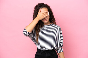 Young hispanic woman isolated on pink background covering eyes by hands. Do not want to see something