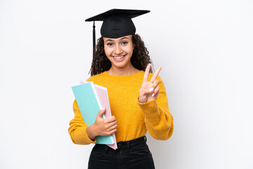 Arab university graduate woman holding books isolated on white background smiling and showing victory sign
