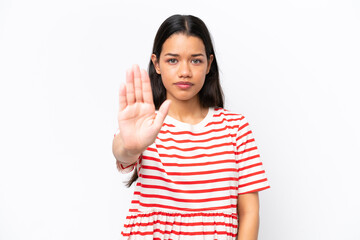 Young Colombian woman isolated on white background making stop gesture