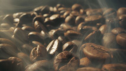 Slider shot of coffee beans during roasting. Dark roasted coffee beans with smoke. Smoke comes from fresh coffee seeds. Macro shot, 4K