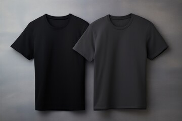 Two gray and black t-shirts with copy space on gray background