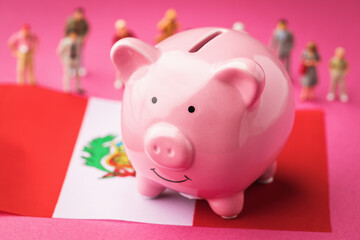 Piggy bank, Peruvian flag and plastic toy men on a colored background, a concept on the theme of the income of the population of Peru