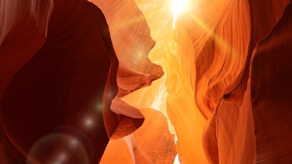 Various red and orange rocks in antelope canyon. Midday sun hits the antelope canyon whimsically illuminating canyon walls. Red walls of Antelope Canyon in Arizona, USA, United States - obrazy, fototapety, plakaty