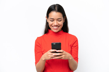 Young Colombian woman isolated on white background sending a message or email with the mobile