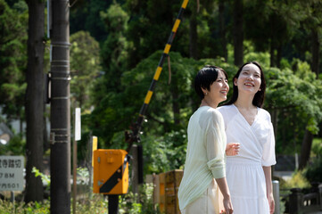 Two young, beautiful Asian women happily strolling around their destination. Tourism and lifestyles