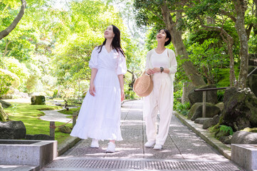 Asian female traveller enjoying nature. 
walking along the pathway in the forest park of Kamakura,...