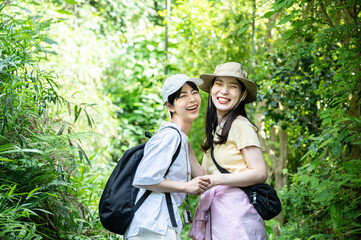 Smiling young woman hiking in the forest