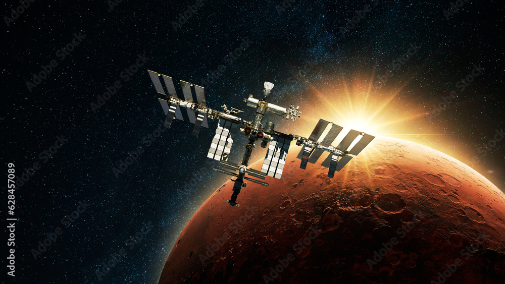 Poster iss spacecraft flies against the backdrop of dawn light and red planet mars with craters in deep spa