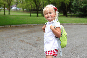 Little blonde girl with backpack come back to school, lifestyle staging