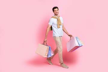 Full length size body photo of walking satisfied macho man enjoy shopping sales packages...