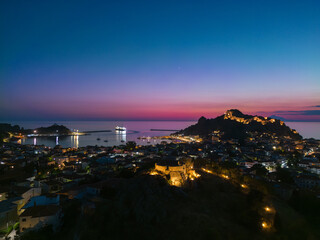 Night aerial photo of Myrina on the island of Lemnos with the castle and the harbor in the background.