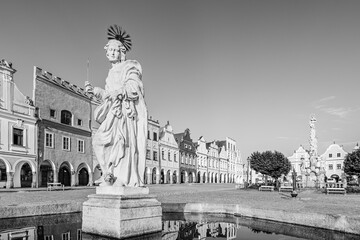 Telč, Czech Republic - 8 July 2023: Saint Margaret fountain and houses on the main square in the of town of Telč in black and white