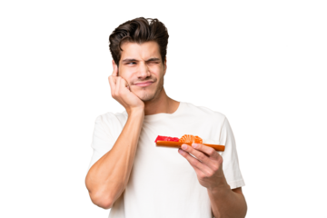 Young caucasian man holding sashimi over isolated background frustrated and covering ears
