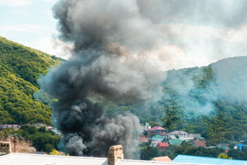 Fire. Close up of clouds of gray smoke over a burning building. The concept of an emergency,...